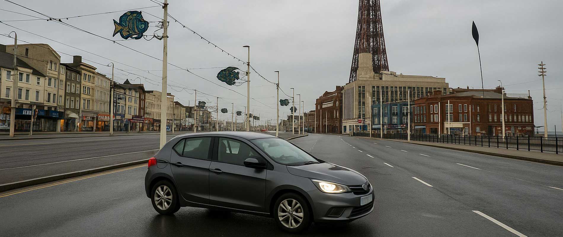 A red hatchback parked on a roadside in blackpool